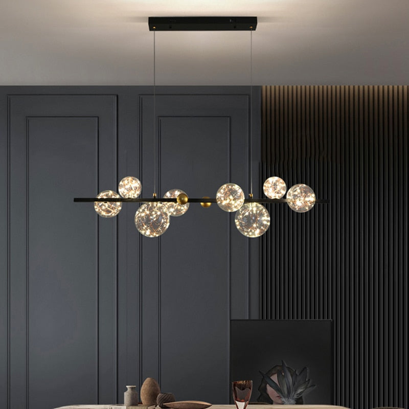 Lustre sphères transparentes étoilées sur barre en métal Zodiaque