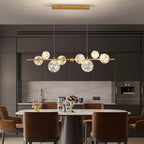 Lustre sphères transparentes étoilées sur barre en métal Zodiaque