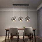 Suspension en verre trois globes fumés sur rampe Fumerolle