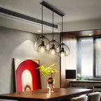 Lustre trois globes en verre transparent sur barre noire Rosée, finition noire