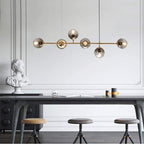 Suspension six globes en verre fumé sur bras dorés Vapeur, finition dorée